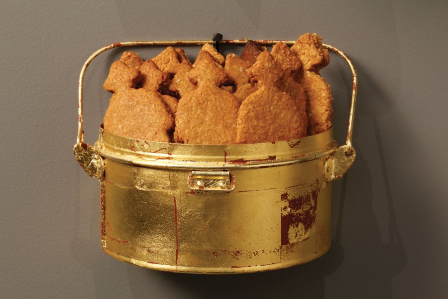 Serve: a new recipe for sacrifice - _Serve_ (detail: gold leaf mess tin and soldier biscuits). Photo: Guy Robinson Serve: a new recipe for sacrifice - _Serve_ (detail: gold leaf mess tin and soldier biscuits). Photo: Guy Robinson